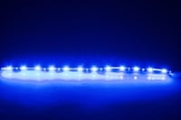 A row of blue lights on a dark blue background .