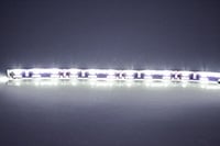 A close up of a white led strip on a table .